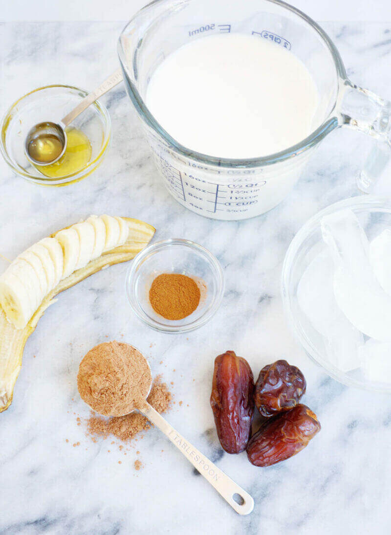 Ingredients for Cacao Smoothie: almond milk, honey, banana, dates, ice, cinnamon and raw cacao